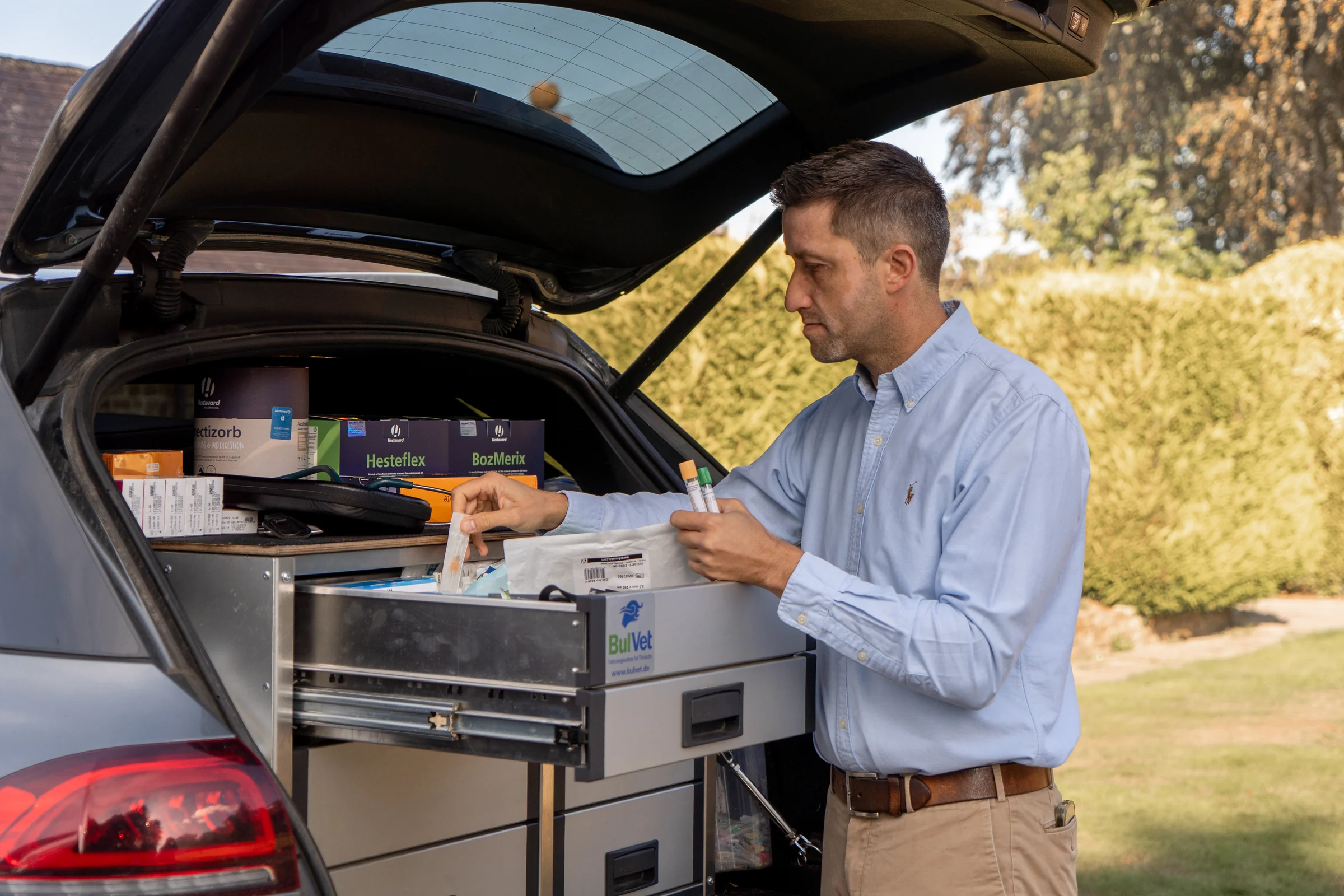 Equimotion vet taking supplies from the fitted drawers in the practice car
